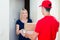 Happy woman getting her order from delivery man