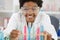 Happy woman with glasses holds multicolored liquids