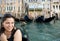 Happy woman with gondola in Venice