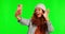 Happy woman, goofy face and selfie on green screen with silly facial expression against a studio background. Female