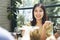 Happy woman grabbing dish from friend