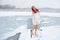 Happy woman hardening on open lake cold snowy winter concept