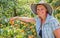 Happy woman Harvest of fresh fruits of apricot on tree