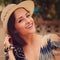 Happy woman in hat outdoors. Vintage closeup