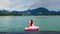 Happy Woman Have Fun and Fool Around at Pink Inflatable Flamingo on Blue Lake