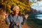 Happy woman having fun with autumn leaves outdoors. Woman fashion. Autumn time. Young woman travels in autumn. Lifestyle, people,