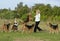 Happy woman having fun playing bubbles with her pet dogs