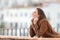 Happy woman heating in a balcony in winter