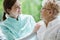 Happy woman and helpful caregiver, nursing home concept photos