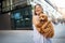 Happy woman with her dog smiling and palying outdoor