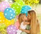 Happy woman and her little daughters with ballons outdoors