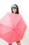 Happy woman hide behind pink umbrella