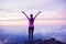 Happy Woman Hiker With Open Arms at Sunset on Mountain Peak