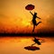 Happy woman hold umbrella and jumping when sunset silhouette Water reflection.copy space