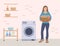 Happy woman holding a basket of laundry. Self-service laundromat with automatic washing machine