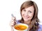Happy woman holding a bowl with orange soup