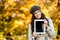 Happy woman holding digital tablet in autumn