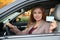 Happy woman holding driving license