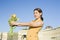 Happy woman holding flowers meeting friend