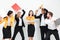 Happy woman holding folder while angry colleagues fighting