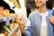 Happy woman holding milk bottle in market