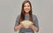 Happy woman holding popcorn glass bowl