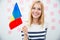 Happy woman holding Romanian flag