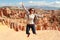 Happy woman jump in Bryce Canyon looking and enjoying view