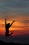 Happy woman jumping against beautiful sunset. Freedom, enjoyment