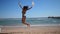 Happy woman jumping on a beach. Happiness and success concept video. Silhouette of a young woman jumping of joy in slow