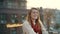 Happy woman jumping outdoors. Excited girl spinning in urban background.