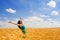 Happy woman jumping in wheat