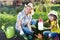 Happy woman and kid girl on farm garden in summer