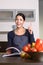 Happy Woman at the Kitchen counter with Recipe Book