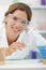 Happy woman lab assistant with test tube in hands