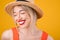 Happy woman laughing with closed eyes. Straw hat. Summer mood.