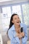 Happy woman laughing with hairbrush in hand