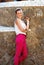 Happy woman leaning on trencadis decorated wall in Park Guell