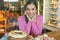 Happy woman looking at dessert display