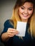 Happy woman looking at piece of papier