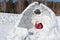 Happy woman lying at the entrance in unfinished an igloo