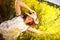 Happy woman lying among yellow wildflowers