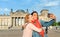 Happy woman making selfie on background of Reichstag Bundestag building in Berlin. Travel and love concept in Europe