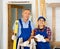 Happy woman and man, professional repairmen standing with waterpas and paper in the middle of the construction site