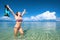 Happy woman with a mask for snorkeling on a background of blue s