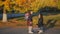 Happy woman meets her little daughter from school. Mom hugs and kisses her daughter in school uniform. Slow Motion in