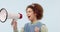 Happy woman, megaphone and singing for karaoke, voice or communication against a studio background. Female person or