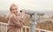 Happy woman observing cityscape through binoculars