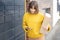 Happy woman with parcel and phone standing near automatic post terminal