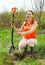 Happy woman planting fruit tree